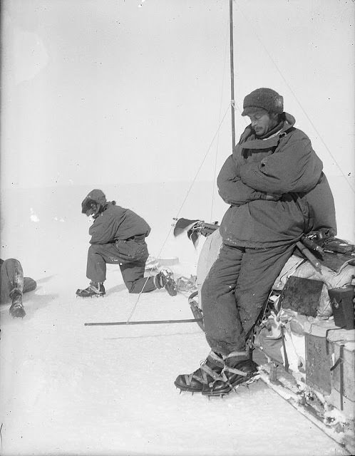 Mawson rests at the side of sledge, outward bound on first sledge journey in Adelie Land, 1912