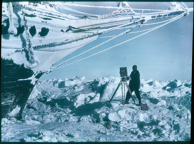 Frank Hurley photographing under the bows of the 'Endurance', 1915