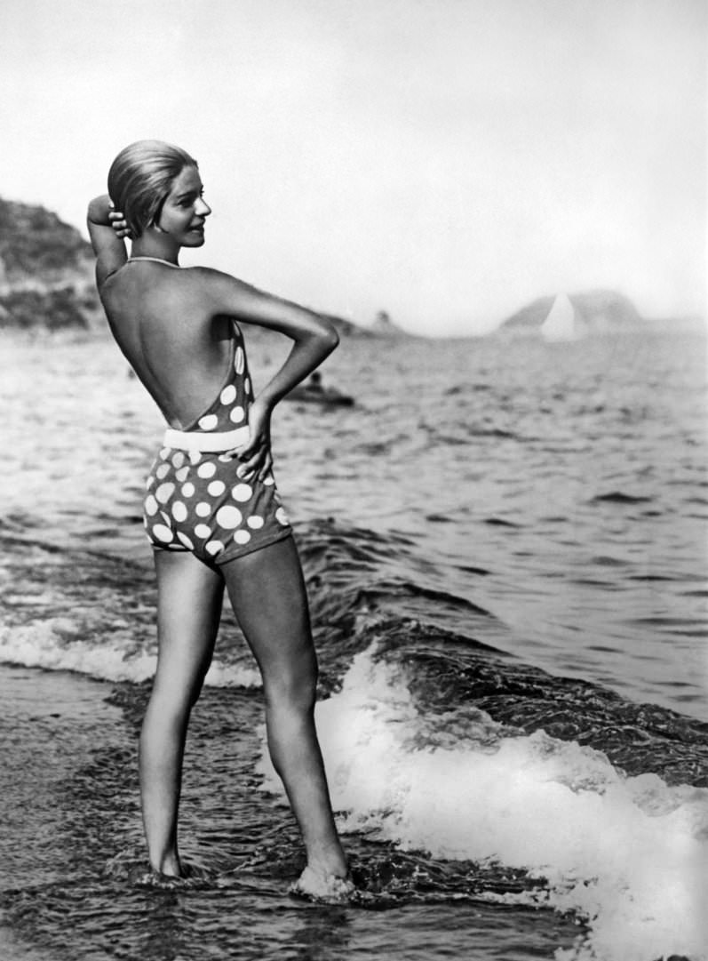 Dancer Alice Nikitina wearing a striking bathing suit at the beach in Alassio, Italy, 1929