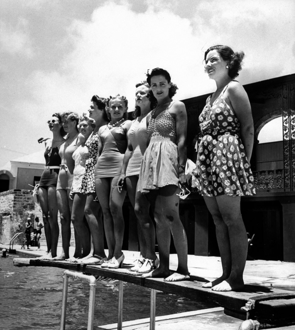 Bathing suit clad female members of the British Imperial Censorship Staff,standing poolside at the Princess Hotel, 1941