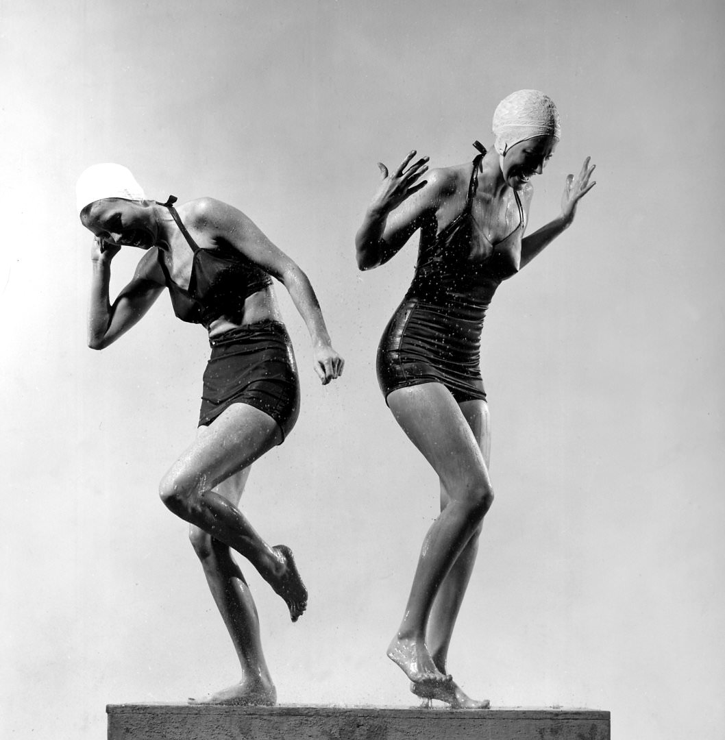 Two models wearing bathing suits and bathing caps,1946