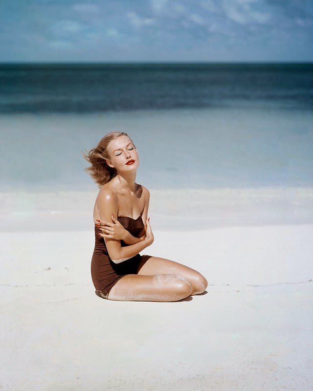 Liz Pringle as Liz Benn models a strapless swimsuit by Givenchy Vogue, 1953