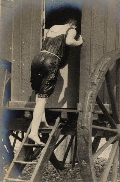 Edwardian woman enters a bathing machine after a swim, 1906