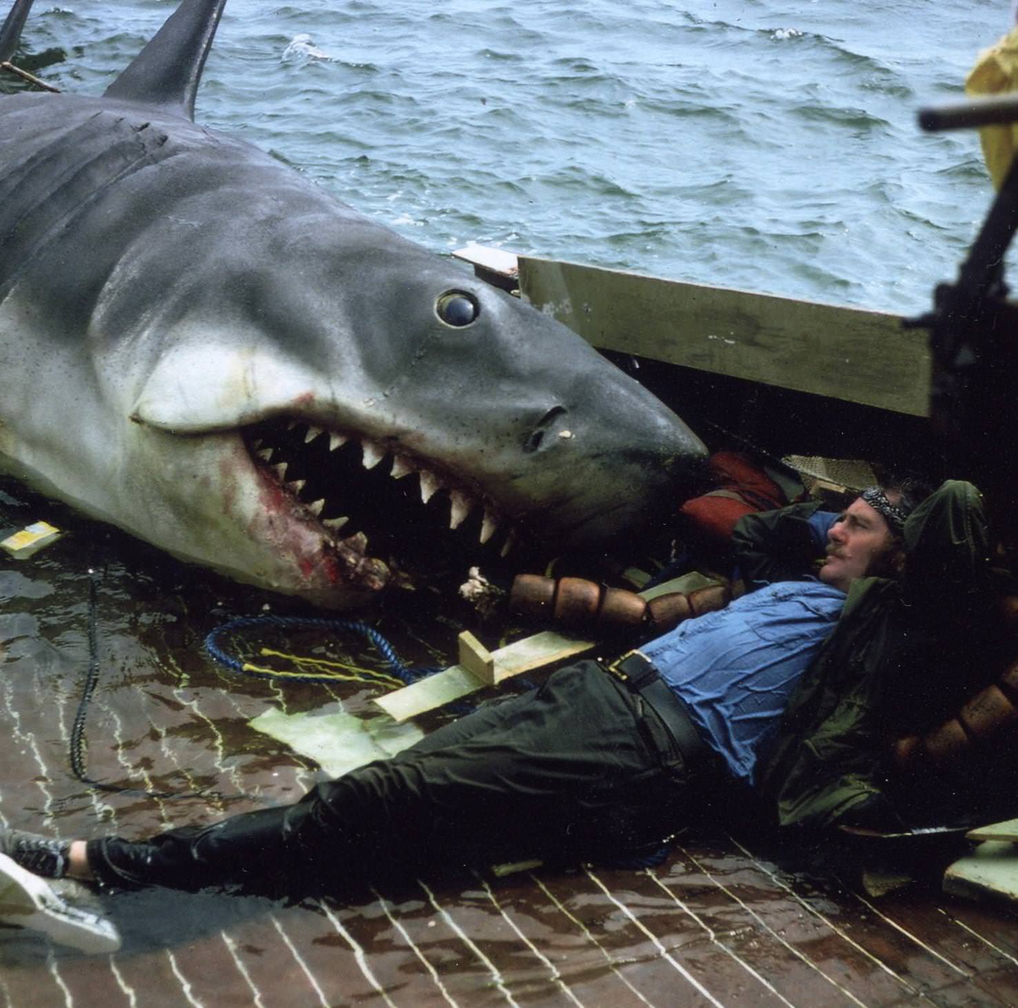Robert Shaw relaxes on the set of Jaws, while filming the scene in which Quint is eaten by the shark, 1974