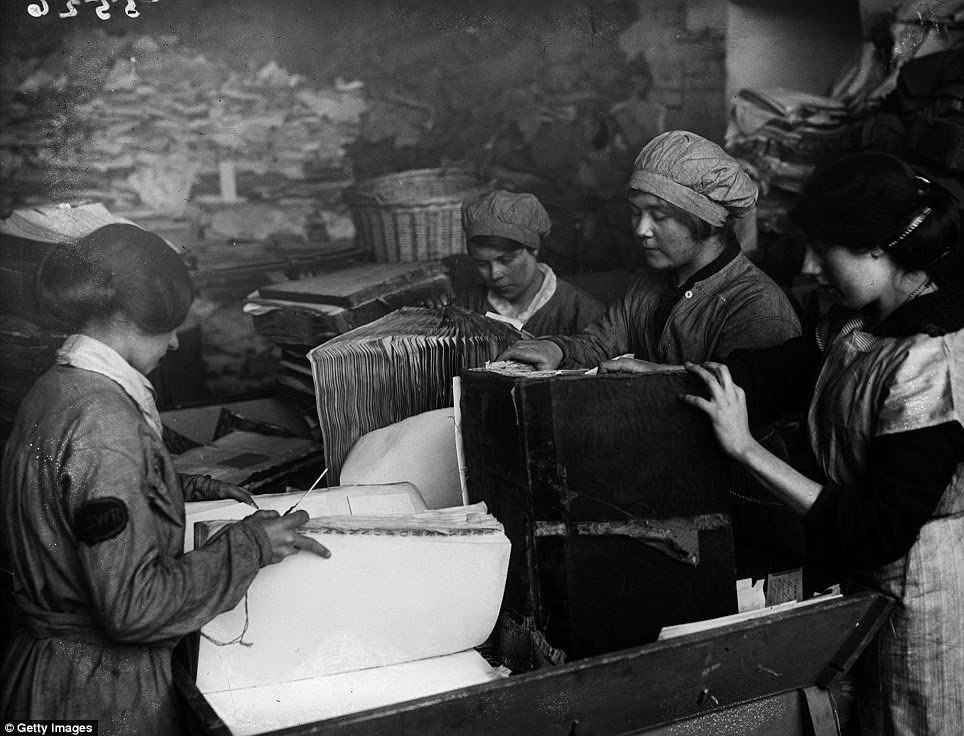 As part of the war effort, old paper had to be reused. These women are pulling apart old ledgers belonging to the London & South West Railway.