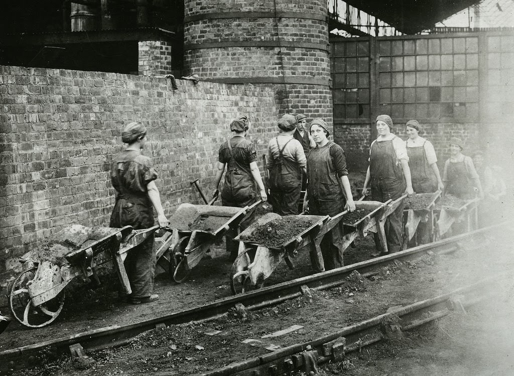 Women wheeling away earth excavated for the installation of hydraulic pumps