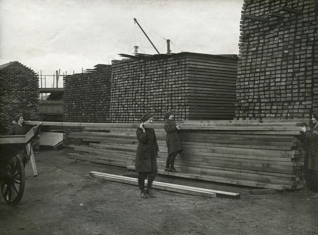 Women stacking wood
