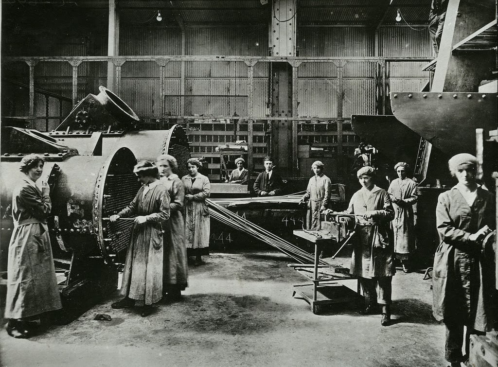 Women inserting and packing tubes in condensors for marine engines
