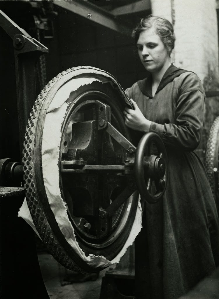 British women rubber workers in Lancashire fixing studded tires