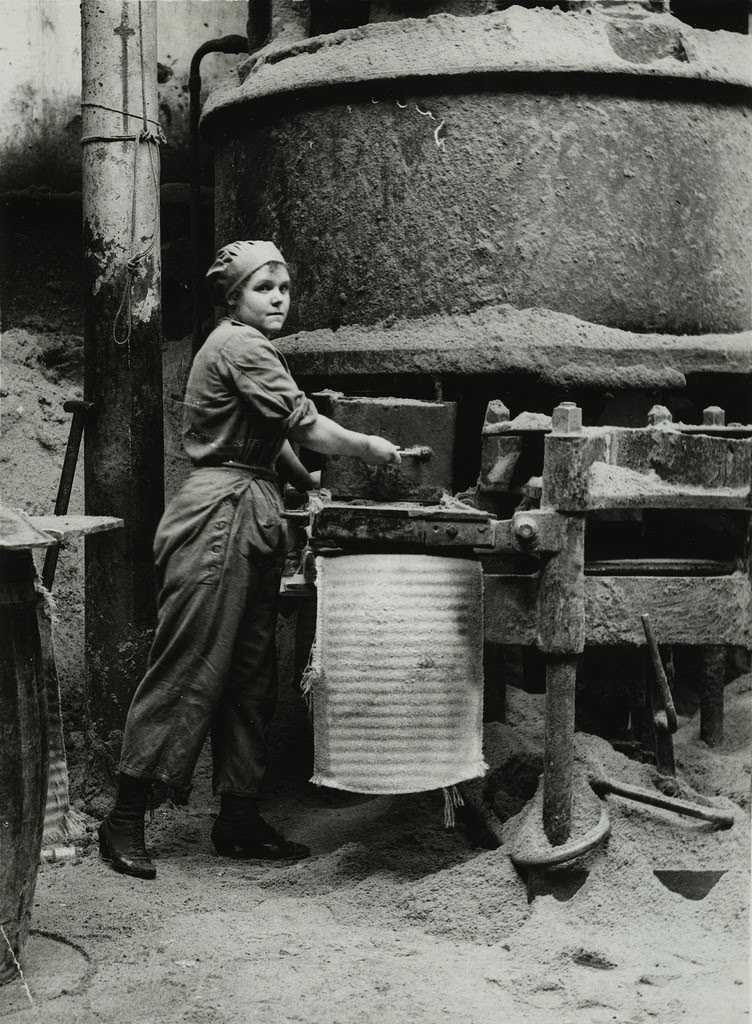 British women oil workers in Lancashire moulding cakes