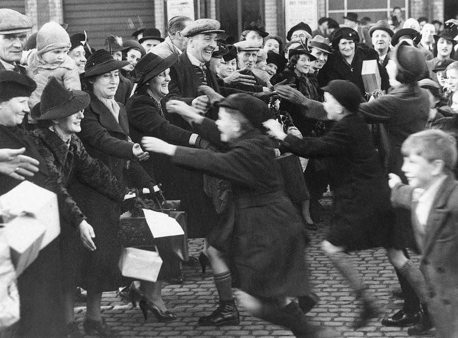 Evacuee children sent away from London greet their parents during a special one-day reunion, 1939.