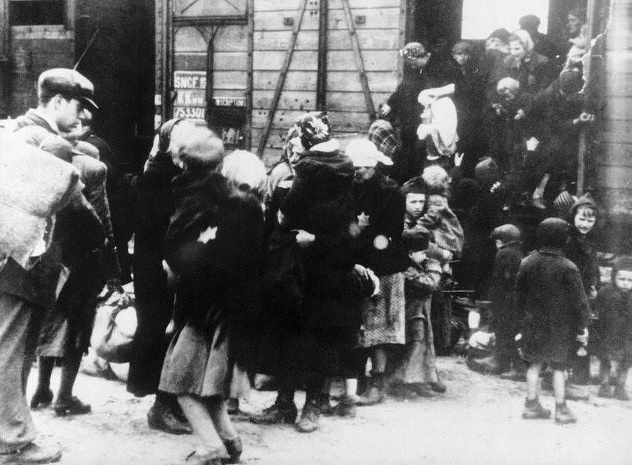 Mothers and their children step out of the train at Auschwitz concentration camp. Poland.
