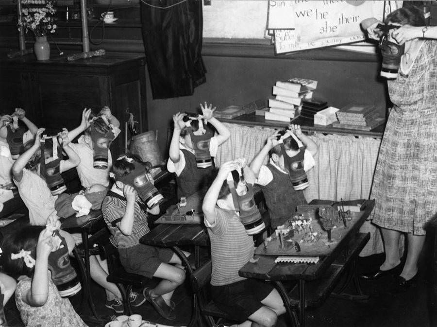 London schoolchildren try on their gas masks, 1941.