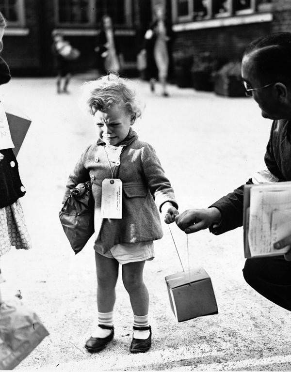 A young child named Freddie Somer cries upon arriving at King's Cross Station in London for wartime relocation. 1939.