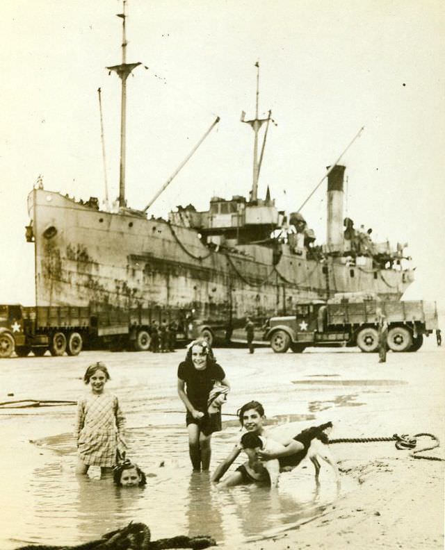 French children frolic near invasion craft