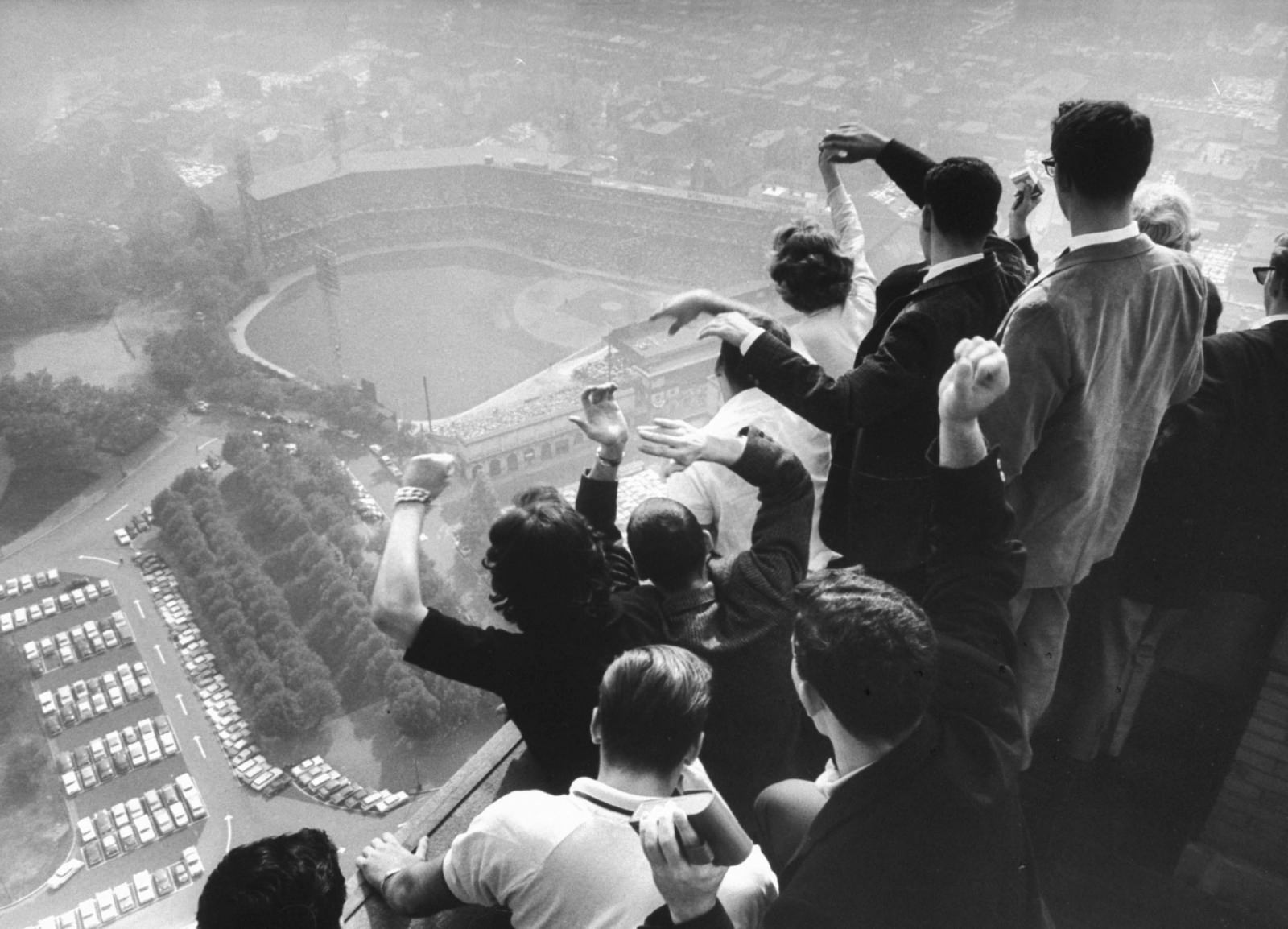 University of Pittsburgh students cheer wildly from atop the Cathedral of Learning, where the Pittsburgh Pirates are playing the Yankees, 1960