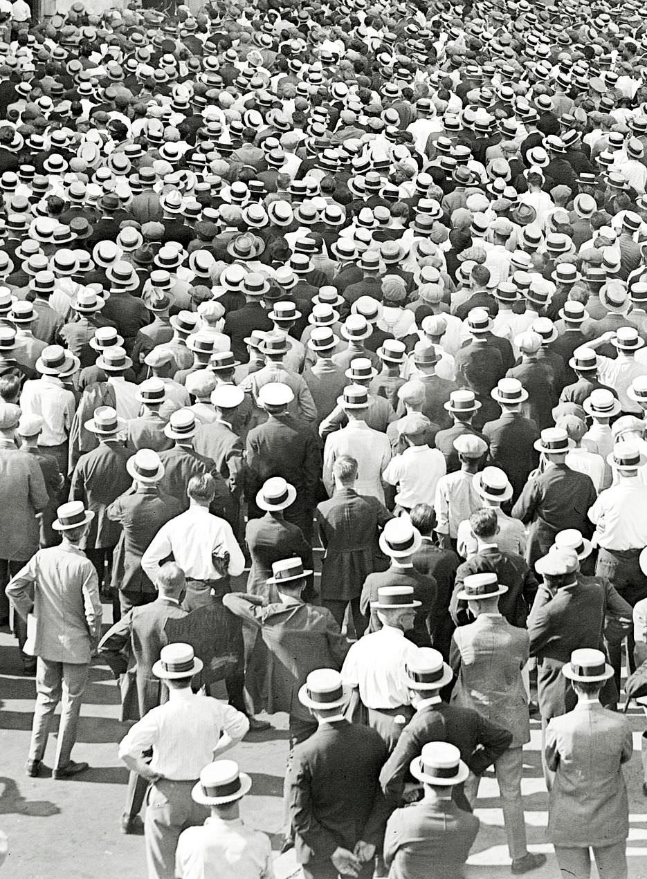 Crowd watching a baseball scoreboard set up on the street during an important game, NYC 1924