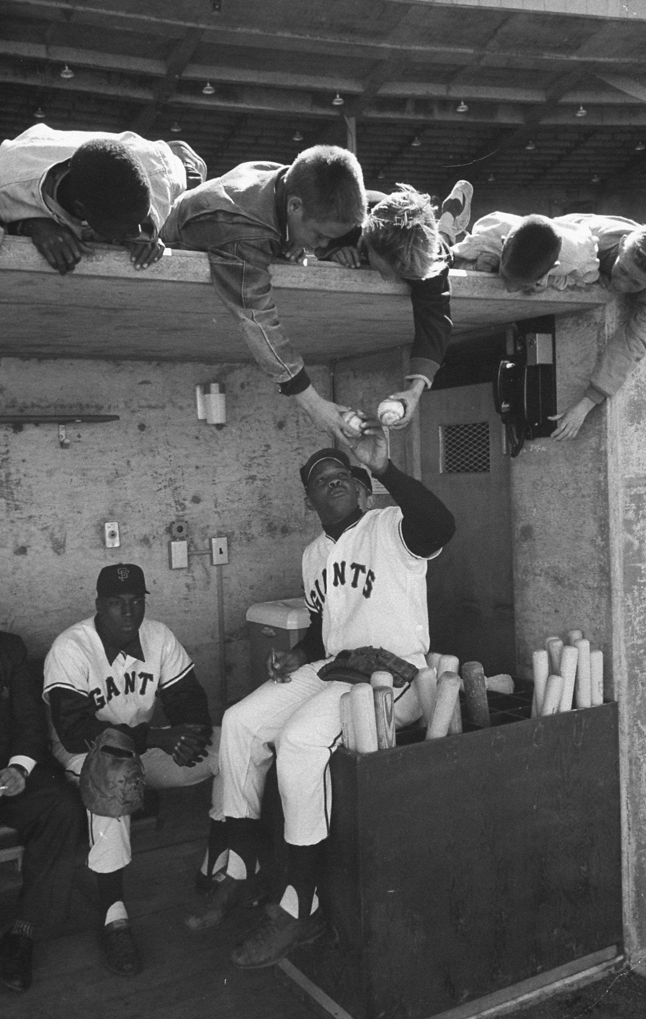 Little fans getting autographs from Willie Mays and Willie McCovey, 1960