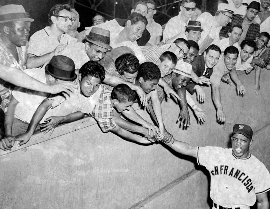 San Francisco Giants' Willie Mays with fans at the Polo Grounds upon returning with Giants to face the New York Mets, 1960s