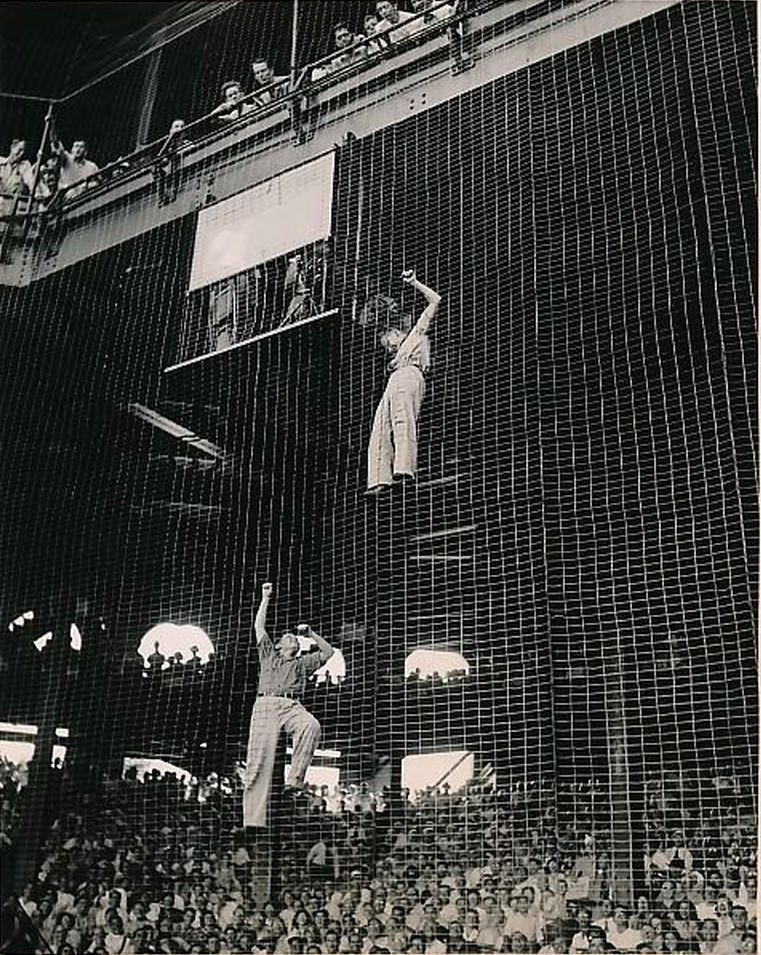 Crazy baseball fans climbing on the backstop screen in Shibe Park, Philadelphia, 1947
