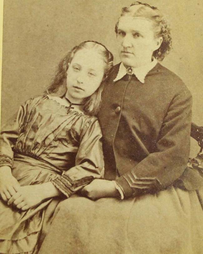 Women sitting next to dead girl. These death portrait were meant to serve as mementos of the deceased loved one.