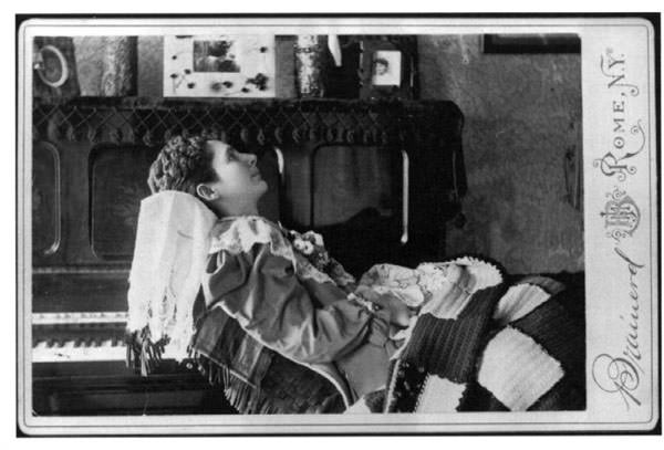 Cabinet card of a deceased young woman in her parlor by a Rome, NY photography studio, 1890's.