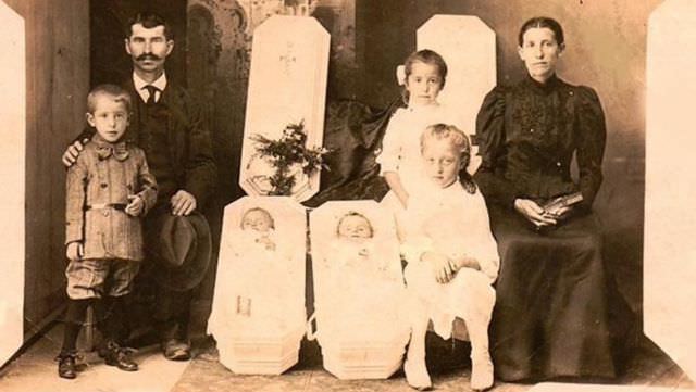 A family portrait with two deceased babies.