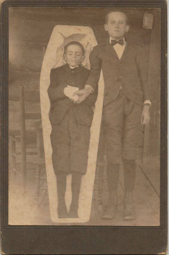Deceased boy in coffin.