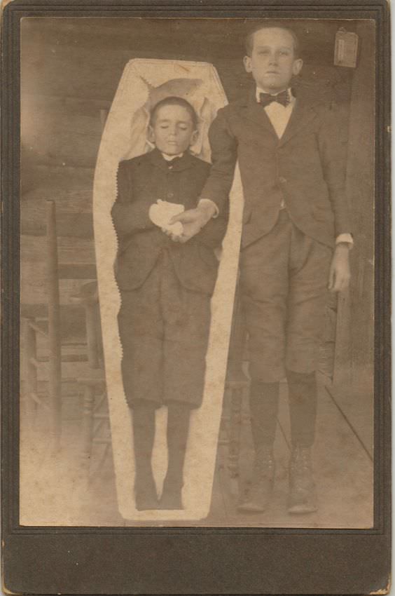 Deceased boy in coffin.