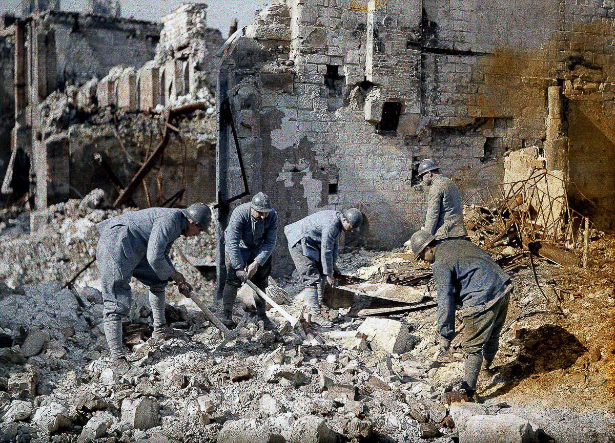 French soldiers dig through the rubble of a destroyed building in Reims, France, 1917