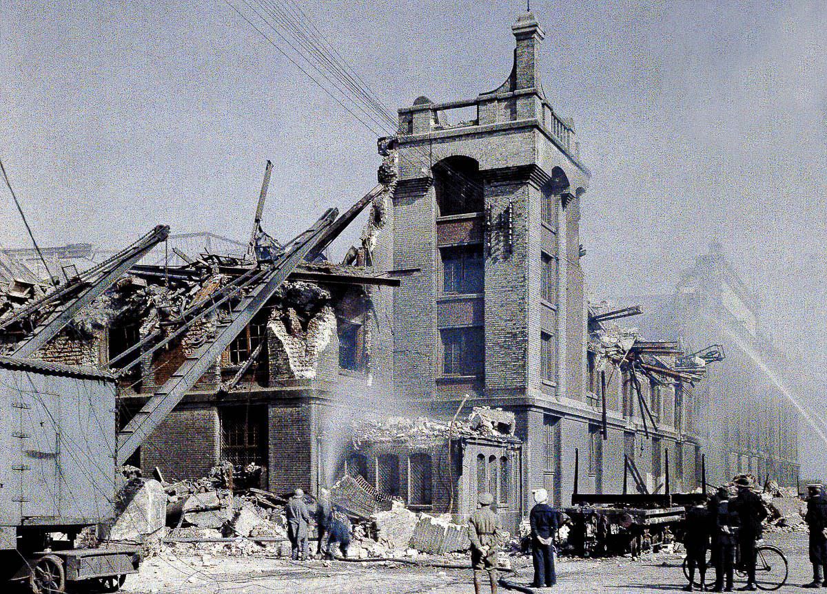 Firefighters attempt to extinguish a fire started by the German bombing of Dunkirk, France, 1917