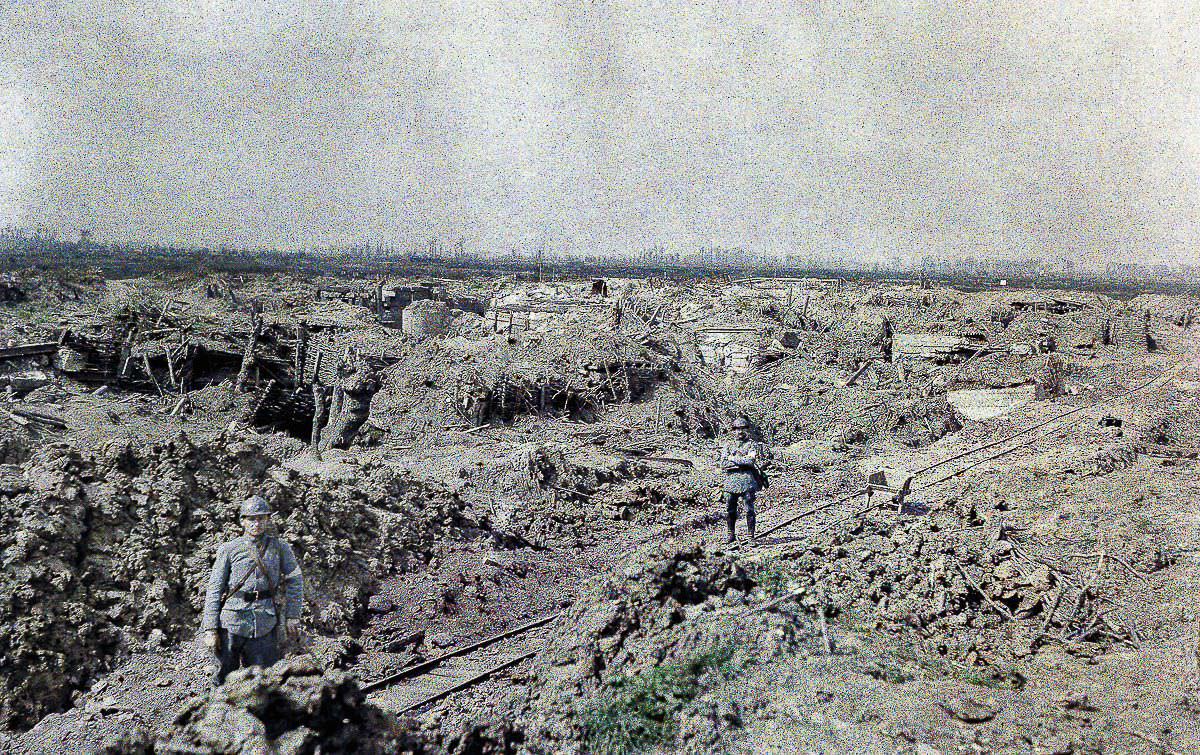 French soldiers stand on a narrow-gauge railroad in an artillery-ravaged battleground in West Flanders, 1917