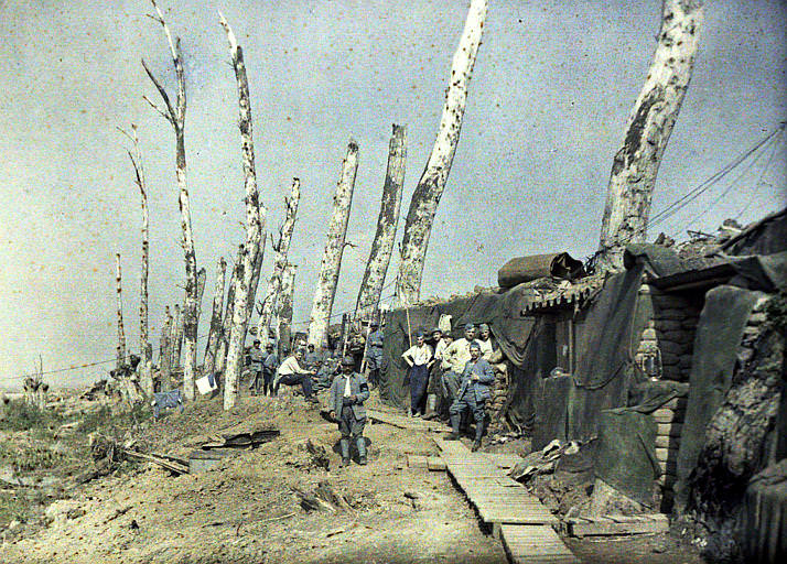 French lines at Het Sas, mutilated trees (French military, sheeted shelters, sandbags, storm lamp) Belgium, 1917