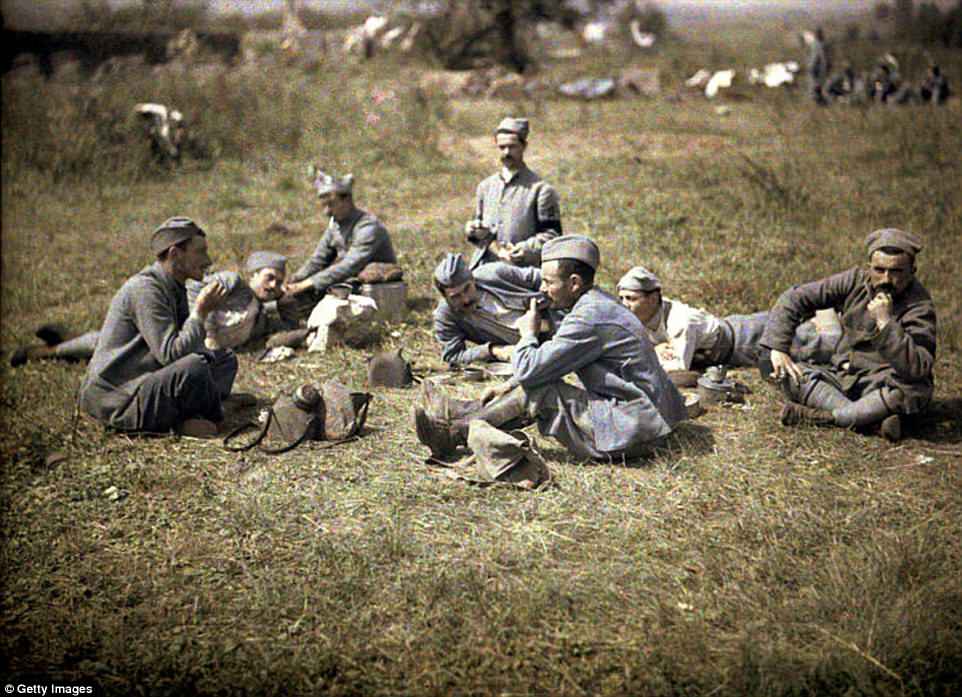 A group of French soldiers rest on the grass as they eat their lunch in Aisne, on the Western Front in France, in 1917