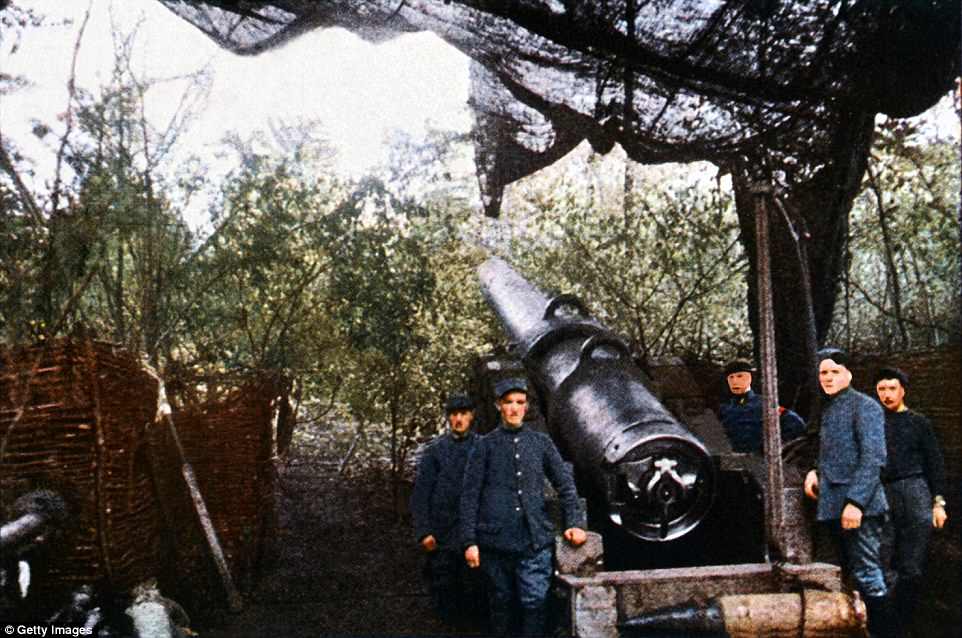 French military personnel stand by a gun used by French forces during the Battle of Verdun, 1916