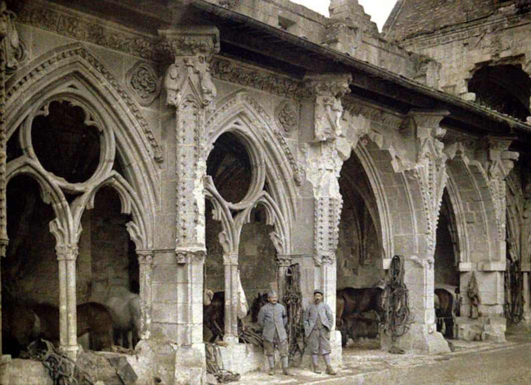 Two French soldiers and horses in the cloister of the Abbey de Saint-Jean-des-Vignes, which was heavily damaged by artillery fire, 1917.
