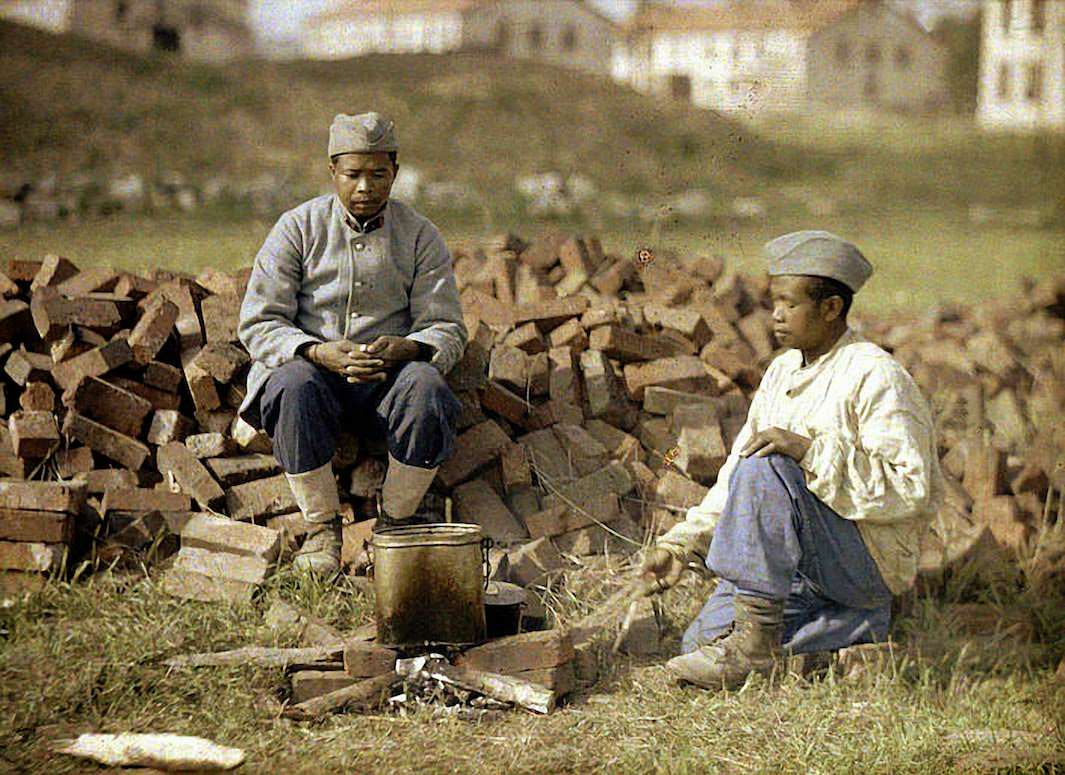 A soldier is shaved by a barber in a French military encampment, 1917.