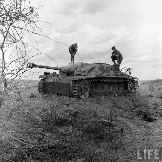 Ernest Kreiling and his bride standing on abandoned tank.