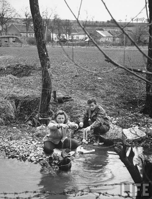 Ernest Kreiling teaching his bride how he washed in socks in stream during the war.