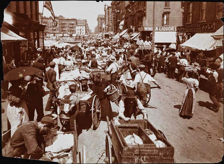 Hester Street crowded with women shopping and push-cart peddlers, 1898