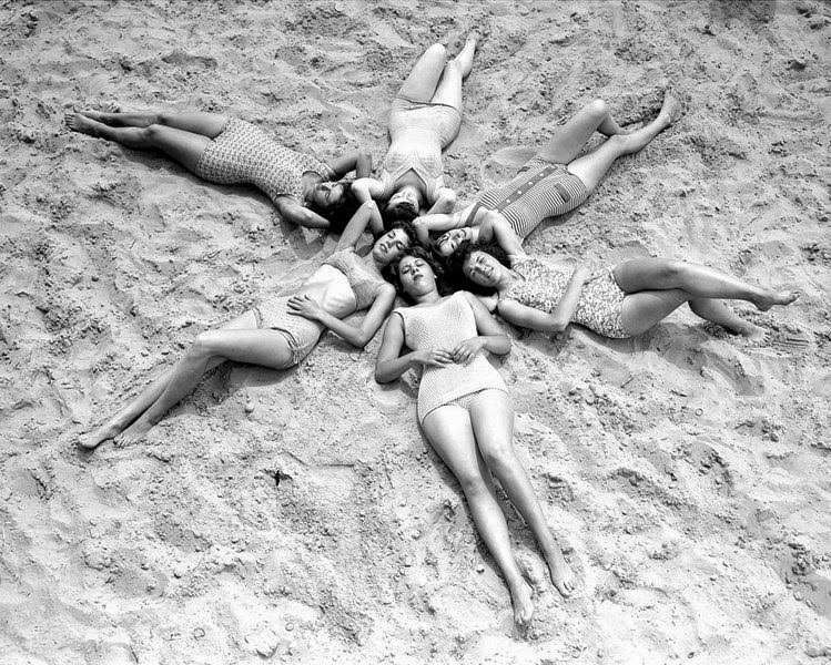 Six shapely lasses hit the beach with a view to soaking up some sunshine at Coney Island, 1960