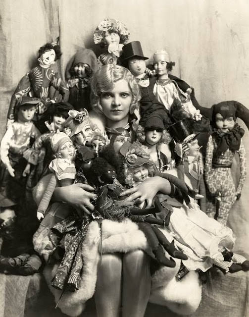 A Young Woman Poses With Her Boudoir Doll Collection in Paris, France in 1922