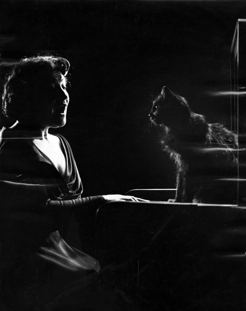 Russian-Born American Operatic Mezzo-Soprano Jennie Tourel Sings As A Cat Named Blackie Sits On A Piano, 1952.