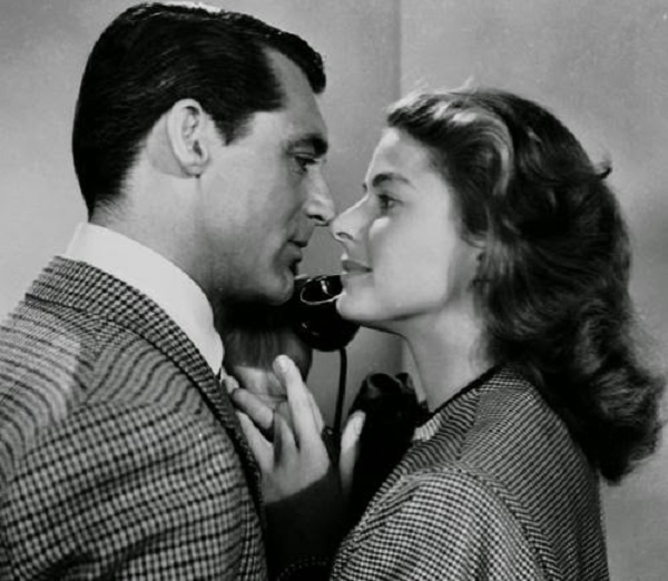 Cary Grant on the phone standing with Ingrid Bergman, 1946