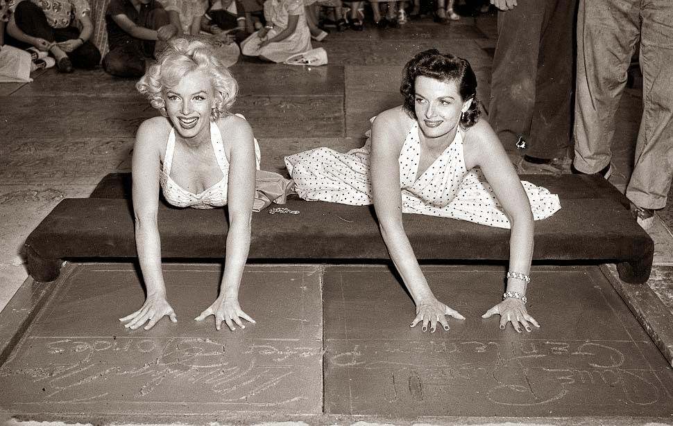 Marilyn Monroe and Jane Russell placing handprints in front of Grauman’s theater, 1953