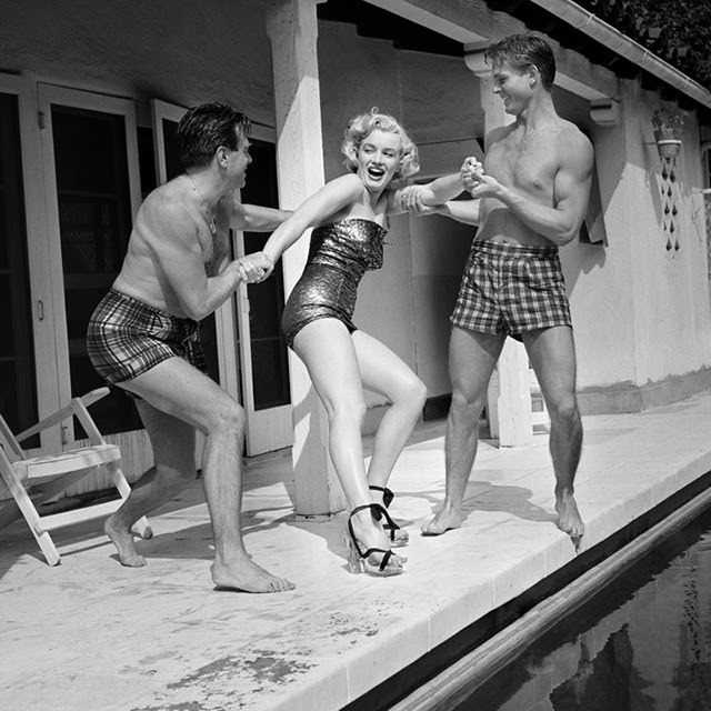 Marilyn jokes around with two male friends in Los Angeles, 1950