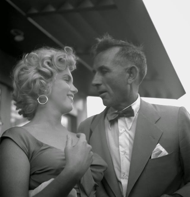 Marilyn with photographer Earl Theisen at a party celebrating Ray Anthony's song "Marilyn.", 1952