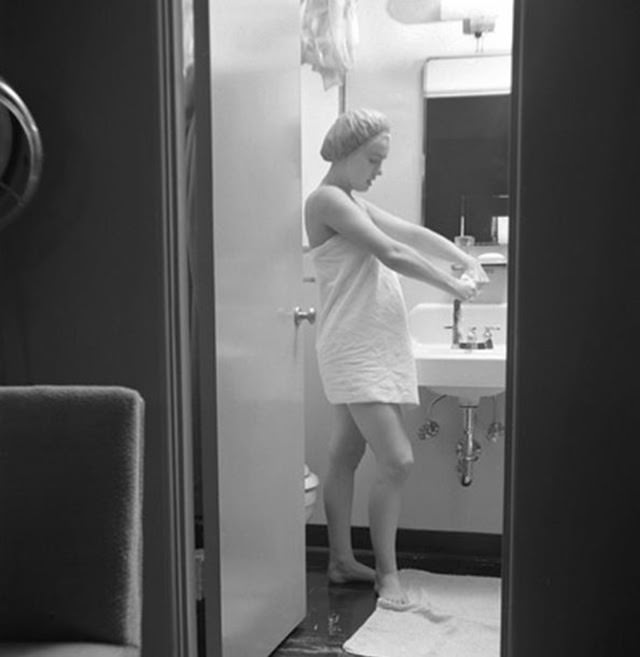 Marilyn preparing herself for movie set in her 20th Century Fox dressing room, 1952