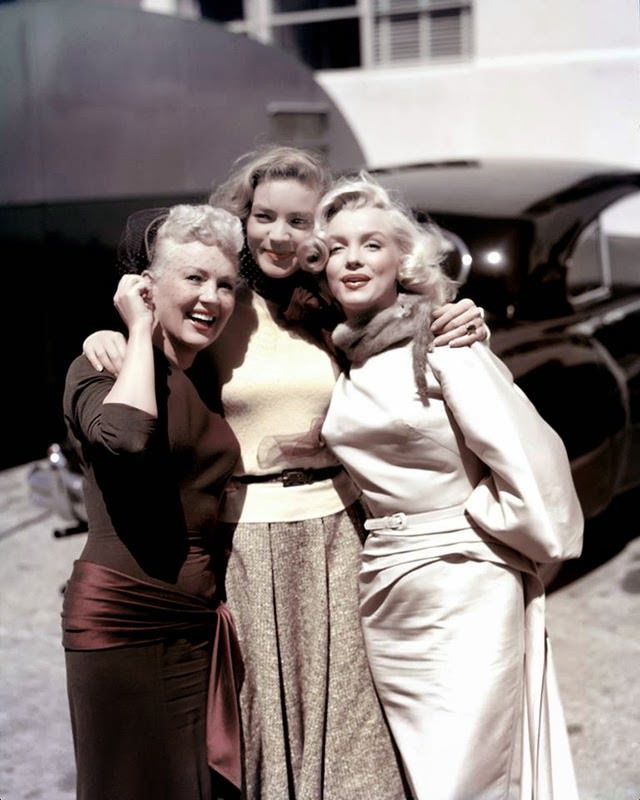 Marilyn poses with Lauren Bacall and Betty Grable on the set of "How to Marry a Millionaire.", 1953