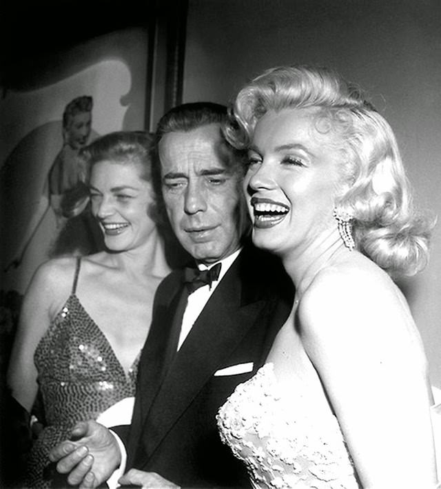 Marilyn with co-stars Humphrey Bogart and Lauren at the premiere of their movie, 1953